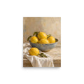 Mediterranean Lemons matte poster, 12 × 16 inches, showing yellow lemons in a blue ceramic bowl on ivory linen